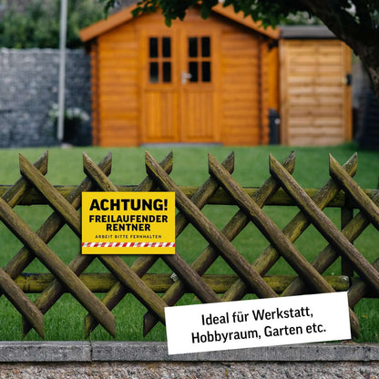 Achtung Freilaufender Rentner sign on a wooden fence, ideal for workshop, hobby room, and garden decoration.